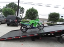flatbed tow truck Towing a motorcycle.